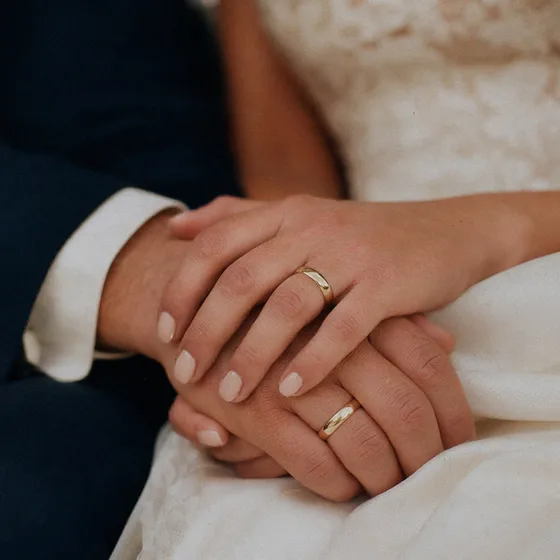Close-up of hands and wedding bands.